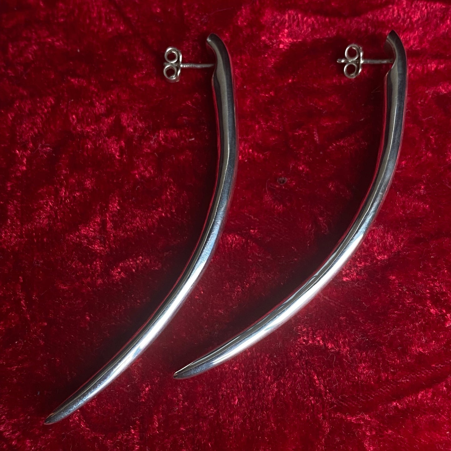 Long minimalist sterling silver curved spike earrings.