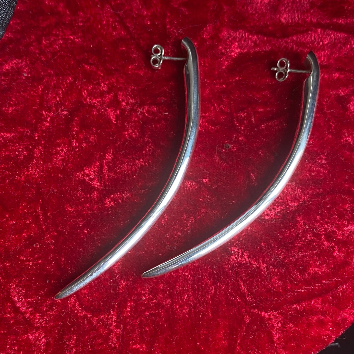 Long minimalist sterling silver curved spike earrings.