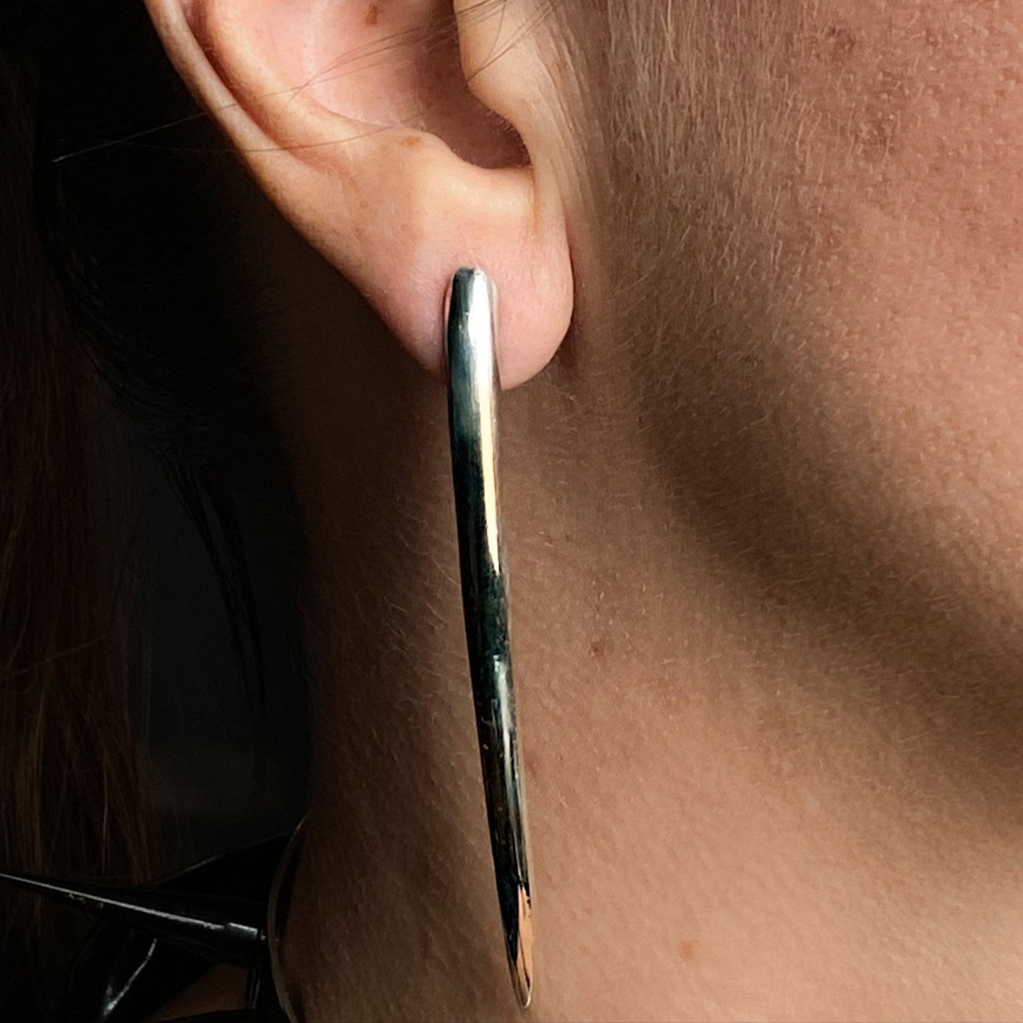 Long minimalist sterling silver curved spike earrings.