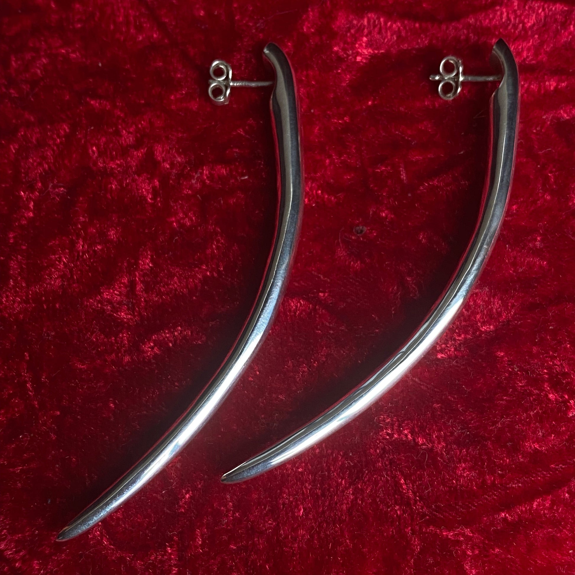 Long minimalist sterling silver curved spike earrings.