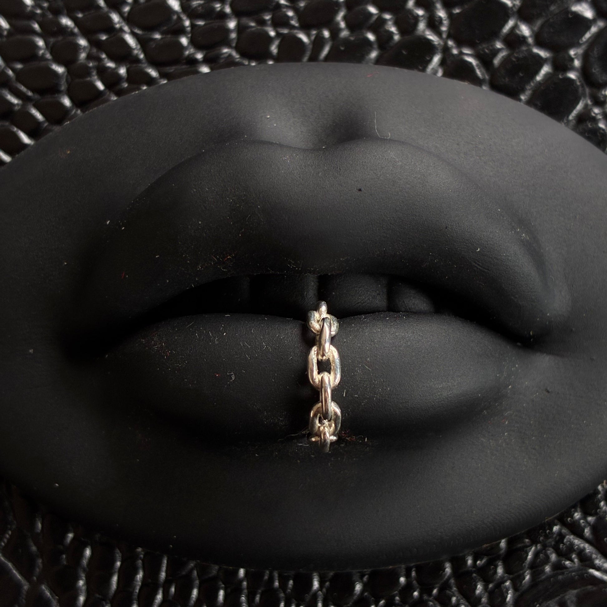 A chain lip cuff in sterling silver.