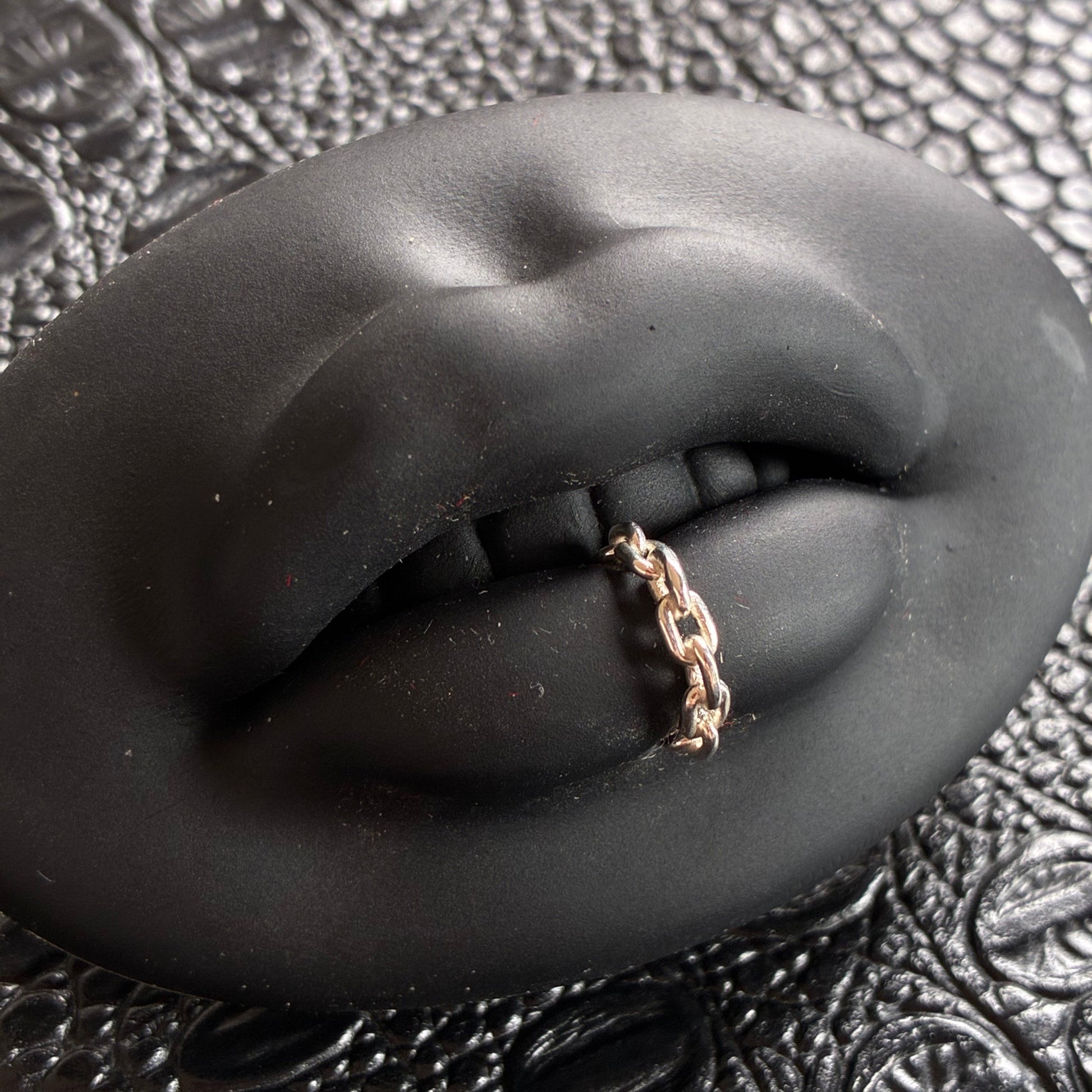 A chain lip cuff in sterling silver.
